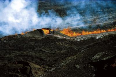 Hawaii, Mauna Loa volcano erupting, fiery lava flow and smoke down mountain of hard rock