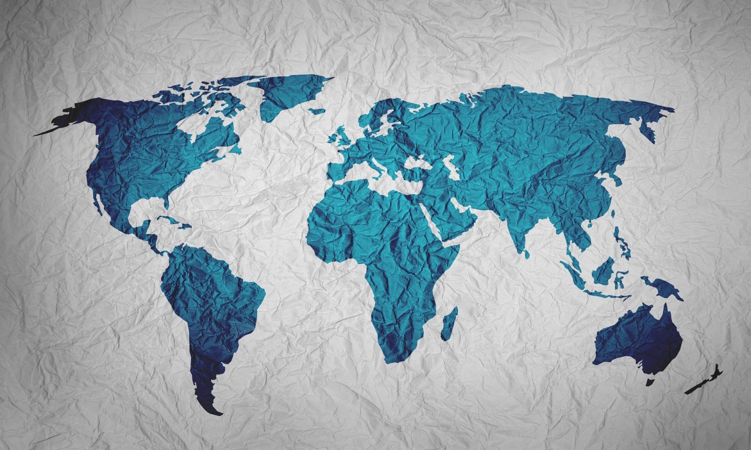 White crinkled paper with the world's continents drawn in turquoise blue ink