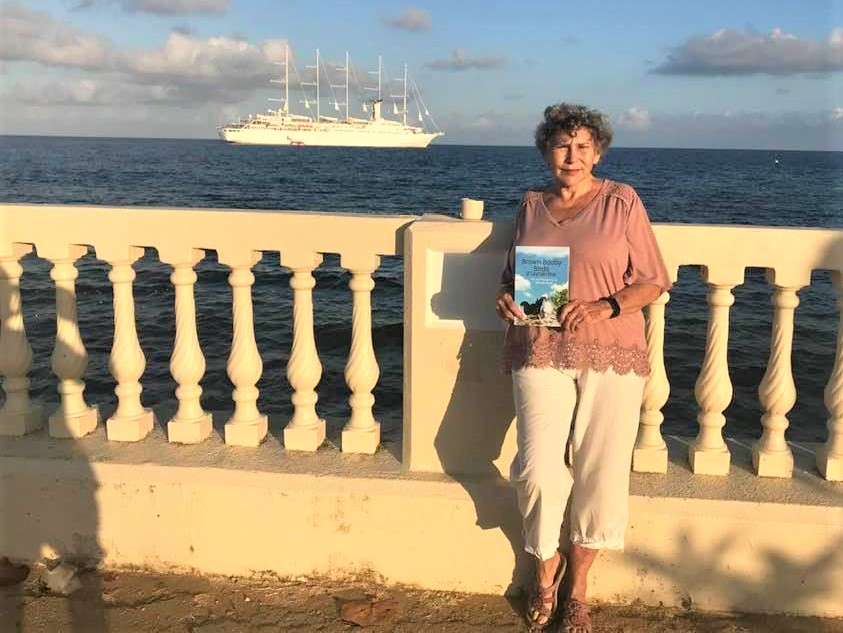 Author Bonnie Scott holding a copy of her important new book, Brown Booby Birds of Cayman Brac.