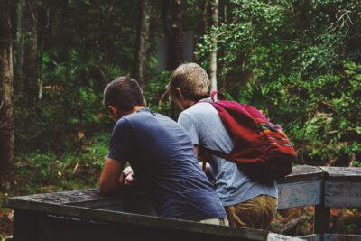 Two teen boys getting ready for a hike