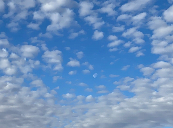 photo of clouds moving into an opening