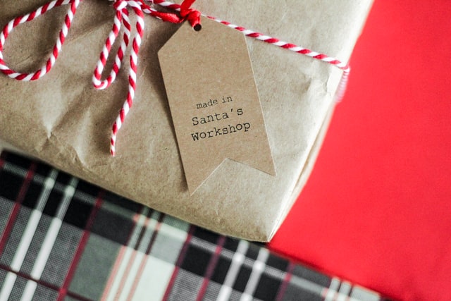 Book wrapped in brown paper with a red and white ribbon and tag that reads: Made in Santa's Workshop"