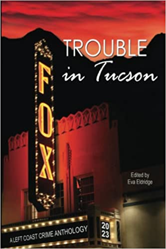 The book cover for Trouble in Tucson, it has a photo of the historic Fox theater across the front.