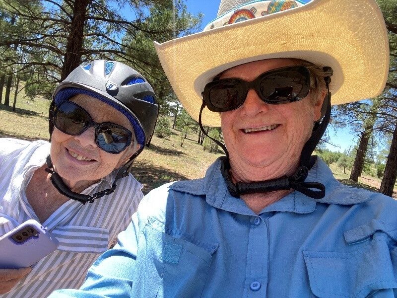 Elaine and her riding friend wear their riding helmets and pose while on their ride.