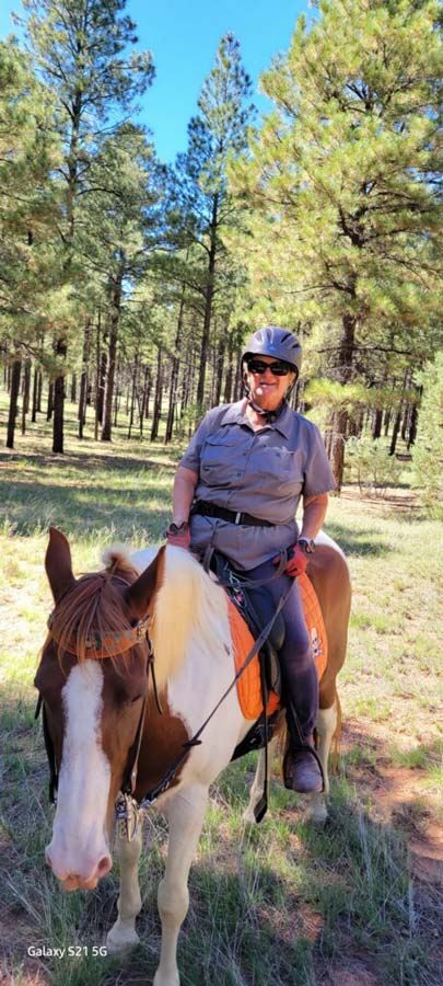 Elaine sitting on Pancho.